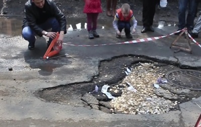 Дорожный налог без посредников: в Приморье дорожную яму засыпали деньгами. Видео